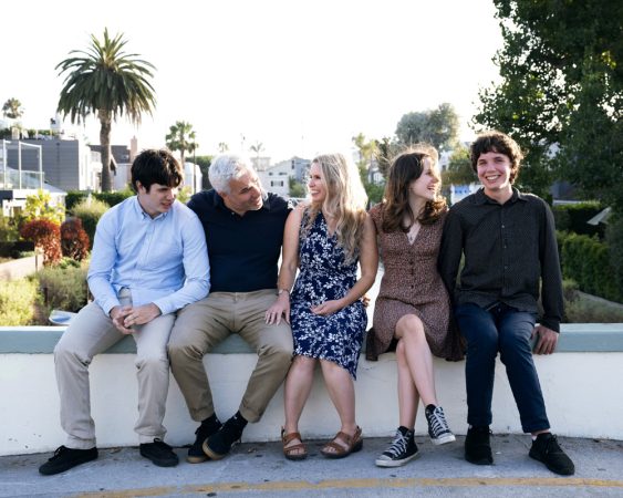 Portrait of T family posing at a bridge at the Venice Canals, in Los Angeles at sunset.